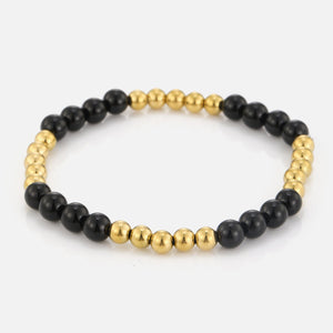 Stretch bracelet with beads and black stones - Goud